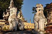 Myanmar - Inwa,  lions guarding enterance to Mahar Aung Mye Bon San Monastery 